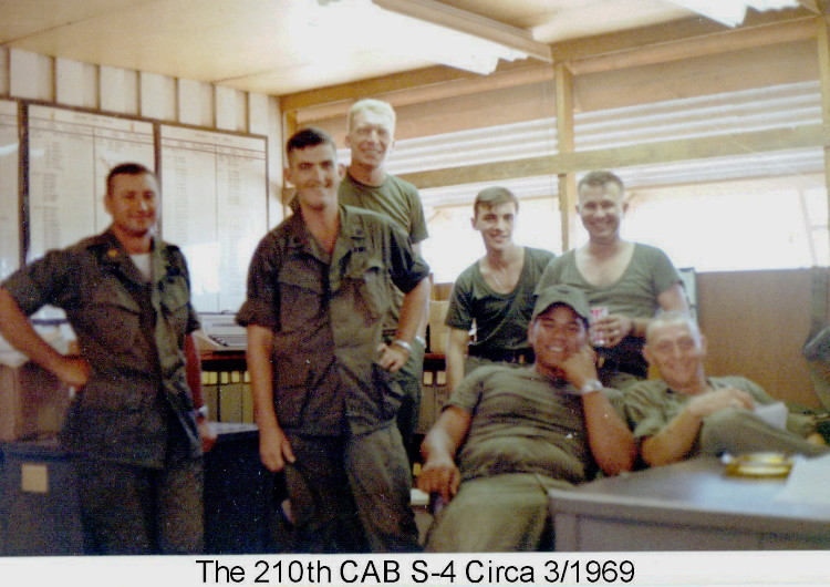 S4, 210th, office as of March 1969. From left, MAJ Hardy, S-4, Seated-left Prince of Kona, standing right SFC Haroland, or Pat Patterson, next to Pat is our clerk but I don't remember his name Photo by Rich Hendrickson, CAC, 1968-69 S4, 210th, office as of March 1969. From left, MAJ Hardy, S-4, Seated-left Prince of Kona, standing right SFC Haroland, or Pat Patterson, next to Pat is our clerk but I don't remember his name. Photo by Rich Hendrickson, CAC, 1968-69