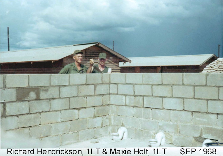Rich Hendrickson and Maxie Holt (w/ beers) inspecting the latrine wall we were building. You do know that we (John Stewart, me , Maxie and many other officers) built those 2 running water latrines in officer country? Quite a story there! Photo by Rich Hendrickson, CAC, 1968-69 Rich Hendrickson and Maxie Holt (w/ beers) inspecting the latrine wall we were building. You do know that we (John Stewart, me , Maxie and many other officers) built those 2 running water latrines in officer country? Quite a story there!